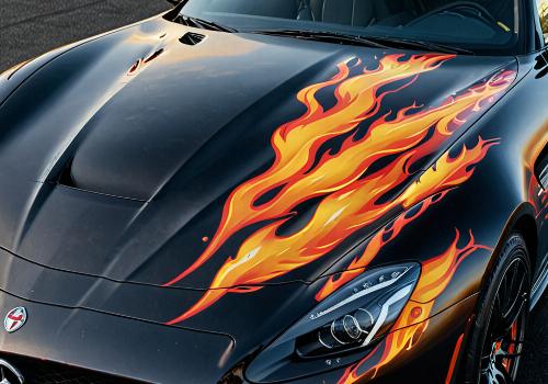 Custom flame design on black sports car